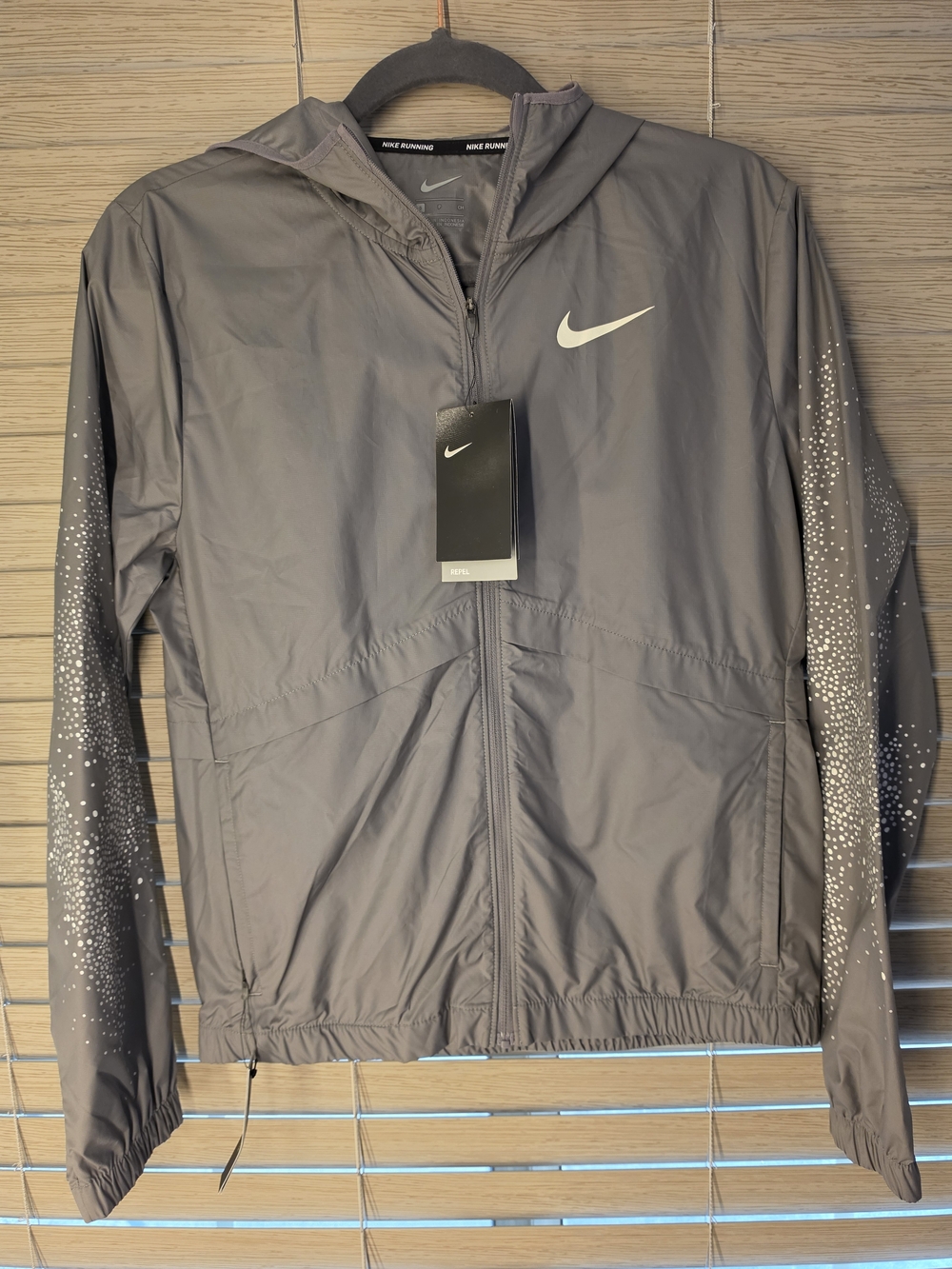 Nike Women's Hooded Reflective Windbreaker in Gray